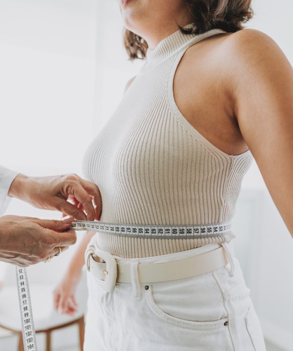 Woman measuring belly fat